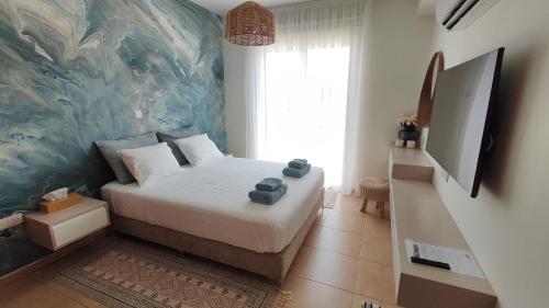 a bedroom with a bed and a painting on the wall at My Mythical Pearl in Protaras