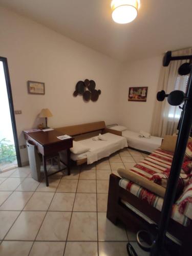 a living room with a piano and a couch at Corte Lavito in Tuglie