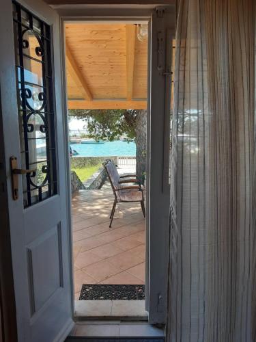 an open door to a patio with a chair at House ViEn in Nerezine