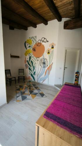 a room with a wall with a painting on it at L'Ulivo Affittacamere Gonnosfanadiga in Gonnosfanàdiga