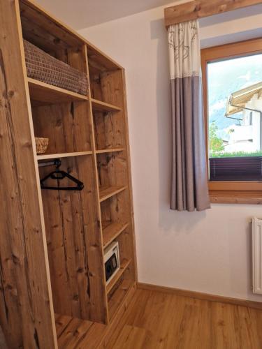 a room with a book shelf and a window at Haus Roland in Zell am Ziller