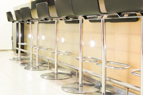 a row of stools in a waiting room at Hotel Korpilampi in Espoo