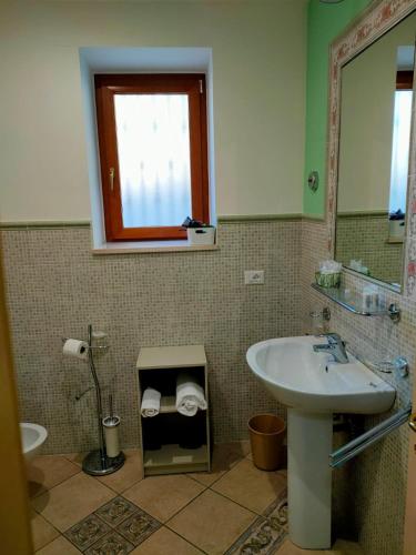 a bathroom with a sink and a mirror at Villa Vittoria in Matera