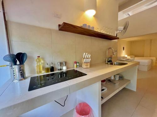 a kitchen with a sink and a counter top at HOTEL BIULÚ in Santa Cruz Huatulco