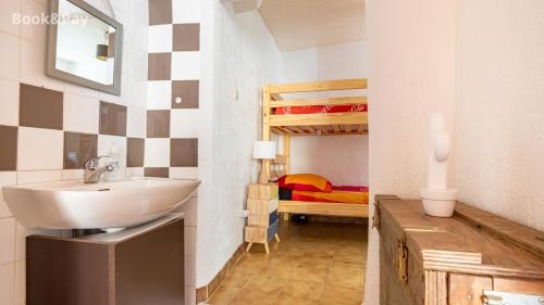 a bathroom with a sink and a bunk bed at Charmante maison de village provençale in Régusse