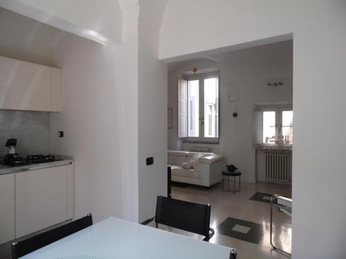a kitchen and living room with a table and a couch at Around the Medieval Tower in Viterbo