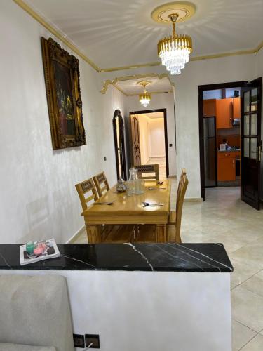 a dining room with a wooden table and chairs at Royal sand Marina Smir in Marina Smir
