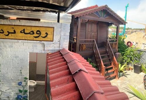 a small house with a red roof and a staircase at The Best Hotel in Bayan Lepas - THE LOV PENANG in Bayan Lepas