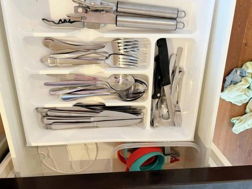 a refrigerator filled with lots of silver utensils at Retreat Andrew House in Point Cook
