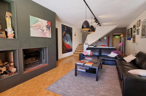a living room with a couch and a fireplace at Coste in Mollans-sur-Ouvèze