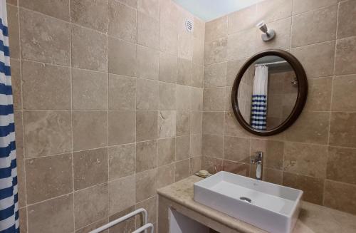 a bathroom with a sink and a mirror at Coste in Mollans-sur-Ouvèze
