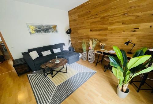 a living room with a blue couch and a table at "Erfurt genießen" in Erfurt