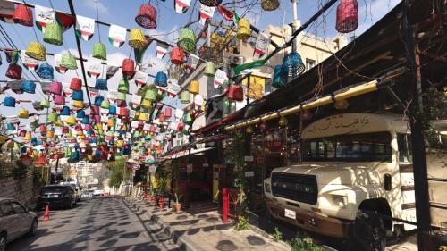 a street with a bunch of flags hanging from a building at InterContinental Amman Jordan by IHG in Amman