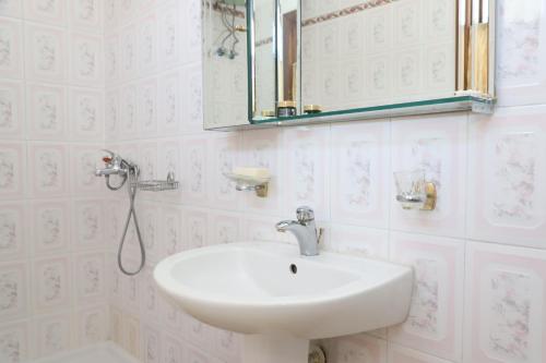 a bathroom with a sink and a mirror at Villa Elena Gorice in Berat