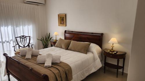a bedroom with a bed with towels on it at Departamento GAMA 111. in Las Varillas