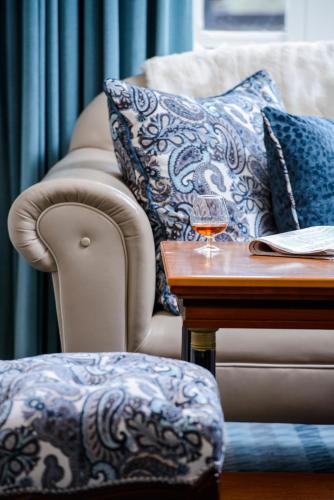 a living room with a couch and a table with a glass of wine at Killarney Avenue in Killarney