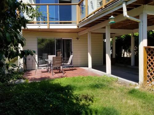 a patio with a table and chairs on a house at Bright 2 BR, Great Location in West Vancouver