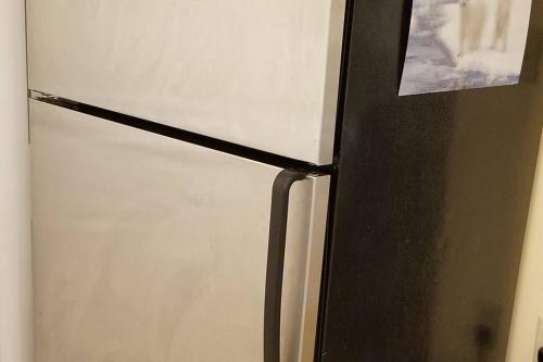 a black and white refrigerator with a picture on it at Bright 2 BR, Great Location in West Vancouver