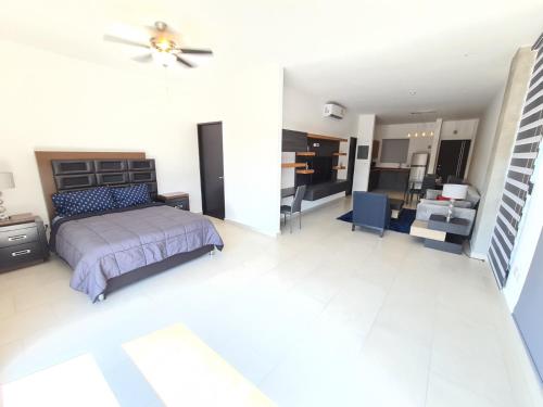 a bedroom with a bed and a living room at Depto en Barrio Antiguo, Santa Lucia y Fundidora in Monterrey