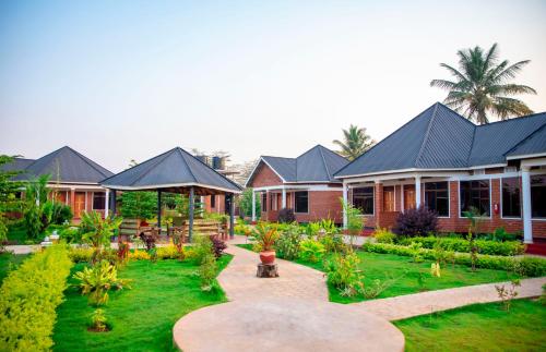 a house with a garden in front of it at Siafu Serenity Lodge in Mto wa Mbu