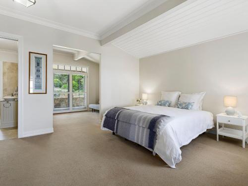 a white bedroom with a large bed and a window at Belmare Shoreham Views in Shoreham