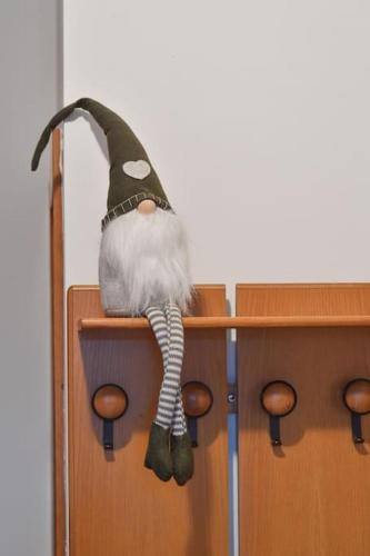 a stuffed animal is sitting on top of a door at Casa del piccolo olivo in Strigno