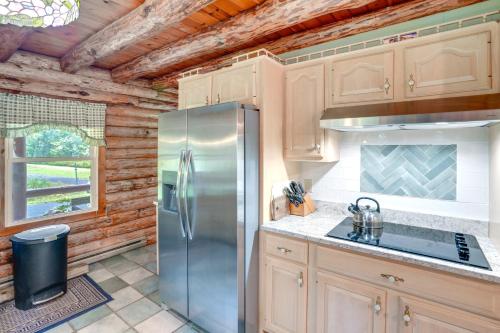 a kitchen with a stainless steel refrigerator at Pet-Friendly New York Cabin with Hot Tub and Game Room in Maplecrest