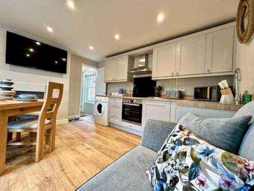 a kitchen with a couch and a table in a room at The Top Deck, Wells-next-the-Sea in Wells next the Sea