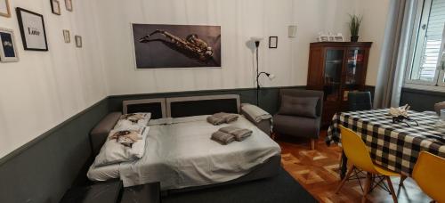 a room with a bed and a table and a table and chairs at Saint Jack Luxury in Trieste