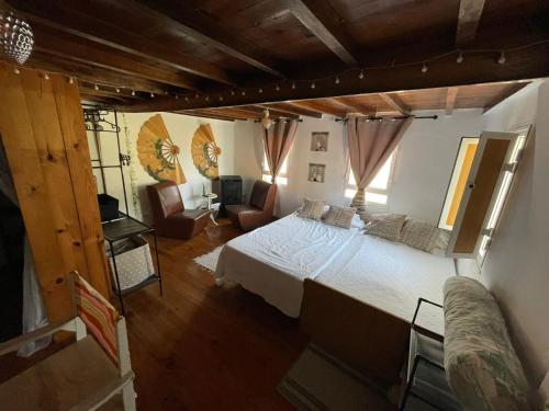 a bedroom with a large bed and a couch at La Carmencita in Cedeira