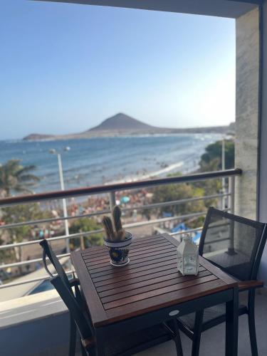a wooden table on a balcony with a view of the beach at Playa Grande, El Médano Best View in El Médano