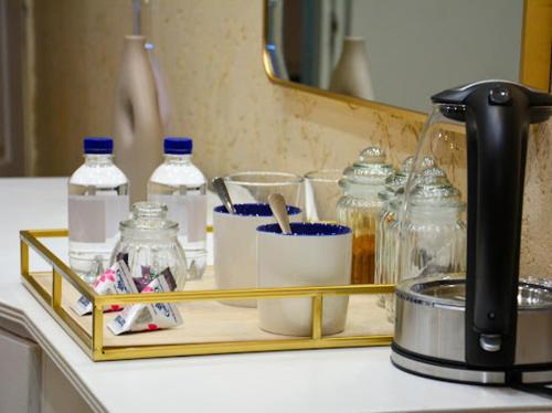a tray on a counter with bottles and containers on it at Thornville Guest house Platinum in Pietermaritzburg