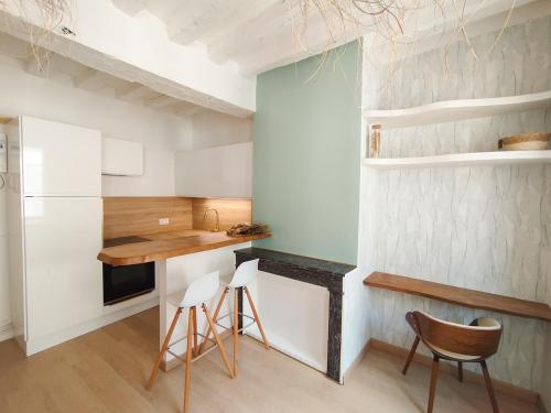 - une cuisine avec un comptoir et des chaises dans la chambre dans l'établissement Studio Harmoni - Centre ville à pied, à Chartres