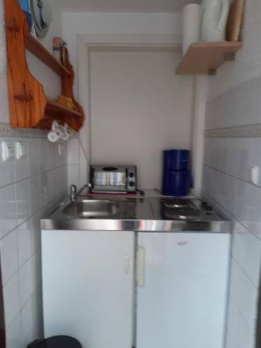 a small kitchen with a sink and a stove at Armin in Gustow