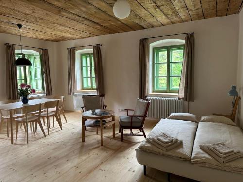 a bedroom with a bed and a table and chairs at Apartmány Hodňov 17 in Horní Planá