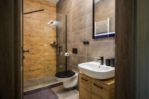 a bathroom with a toilet and a sink and a shower at Aurora, Banská Bystrica in Banská Bystrica
