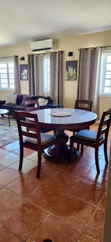 a table and chairs in a living room at Experience Cruzan Comfort in Christiansted