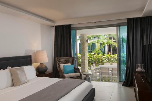 a bedroom with a bed and a view of a patio at The Ocean Club, a Luxury Collection Resort, Costa Norte in Sosúa