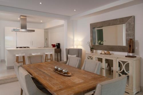 a kitchen and dining room with a table and chairs at The Ocean Club, a Luxury Collection Resort, Costa Norte in Sosúa
