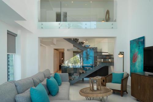 a living room with a couch and a staircase at The Ocean Club, a Luxury Collection Resort, Costa Norte in Sosúa