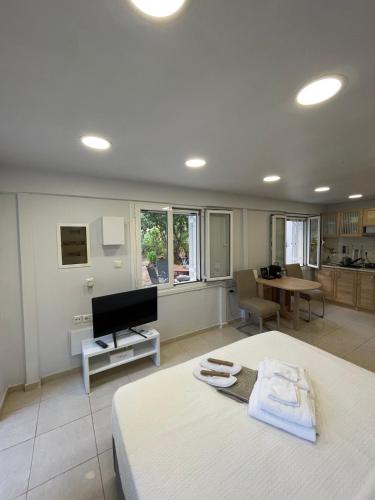 a bedroom with a bed and a living room at Studio next to the Beach in Vouliagmeni