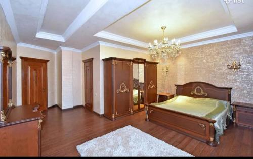 a large bedroom with a bed and a chandelier at VIP Viilla in Avan