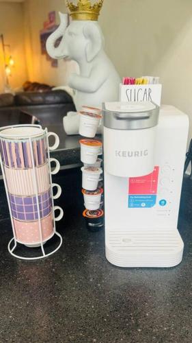 a blender sitting on top of a counter with cups at Cozy home with BBQ -5 min Braves in Atlanta