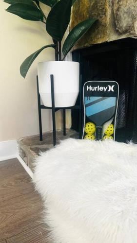 a white furry rug sitting next to a fireplace at Cozy home with BBQ -5 min Braves in Atlanta