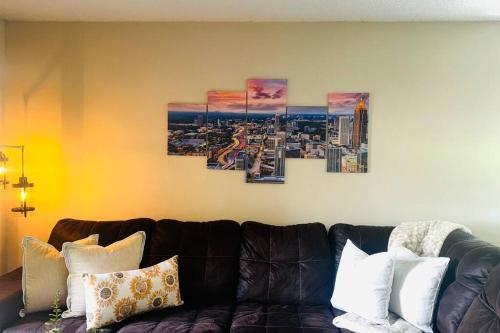 a living room with a black leather couch at Cozy home with BBQ -5 min Braves in Atlanta