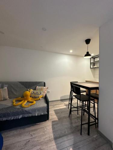 a living room with a couch and a dining room table at Apartman BeerCuz Beer House in Novi Sad