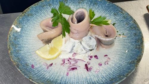 a blue plate with food on a table at Gasthof Zur Post - Inning in Inning am Ammersee