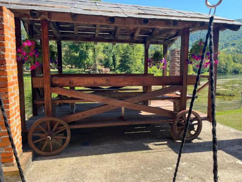 an old wooden cart with flowers on it at Bed and Breakfast Family Djukic in Šipovo