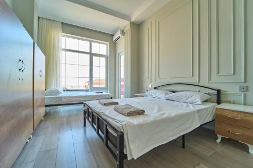 a bedroom with a large bed and a window at Premium Sea View Hotel & Hostel in Baku