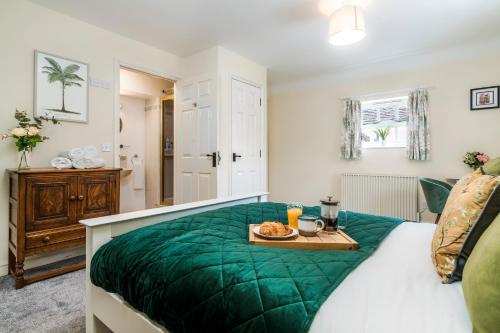 a bedroom with a bed with a tray of food on it at Lime View in Buckingham